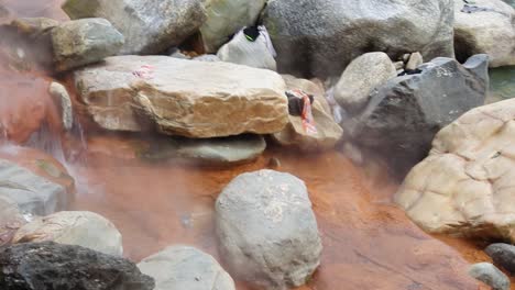 vapour-rising-form-natural-holy-hot-spring-water-with-cold-water-flowing-from-mountains