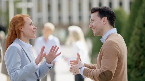 two business partners shaking hands outdoors