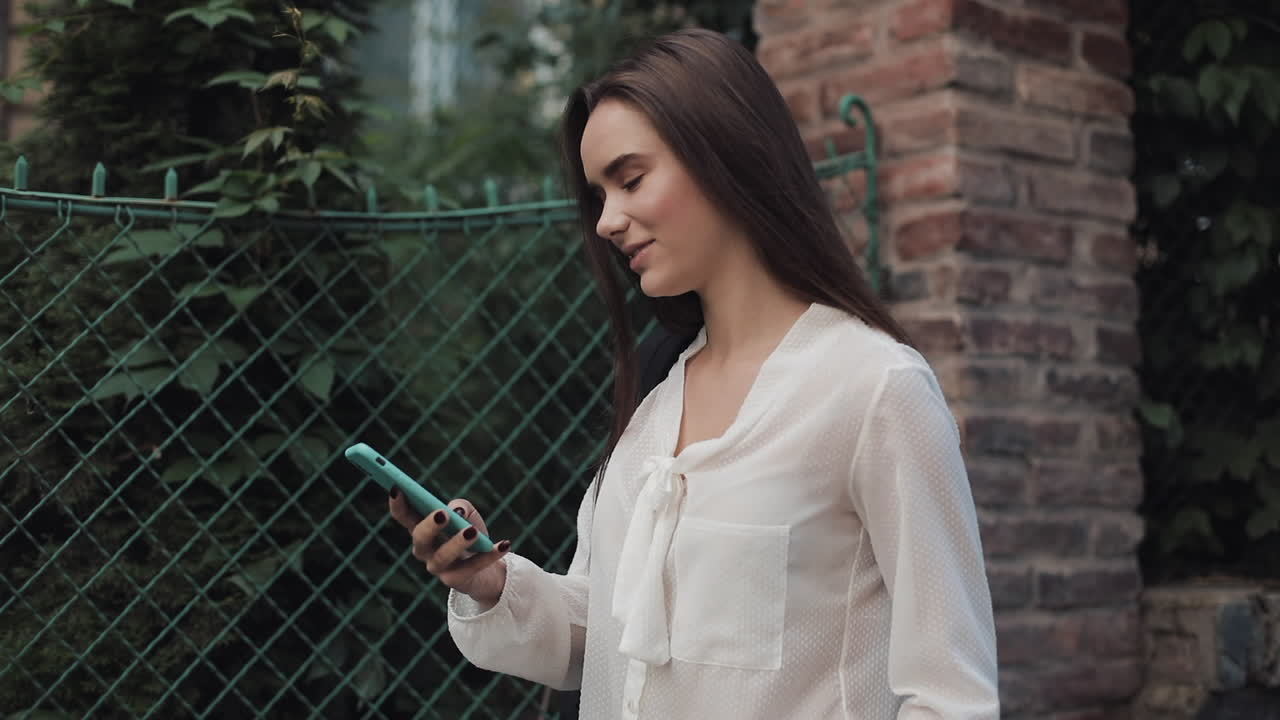 Woman using mobile phone on street