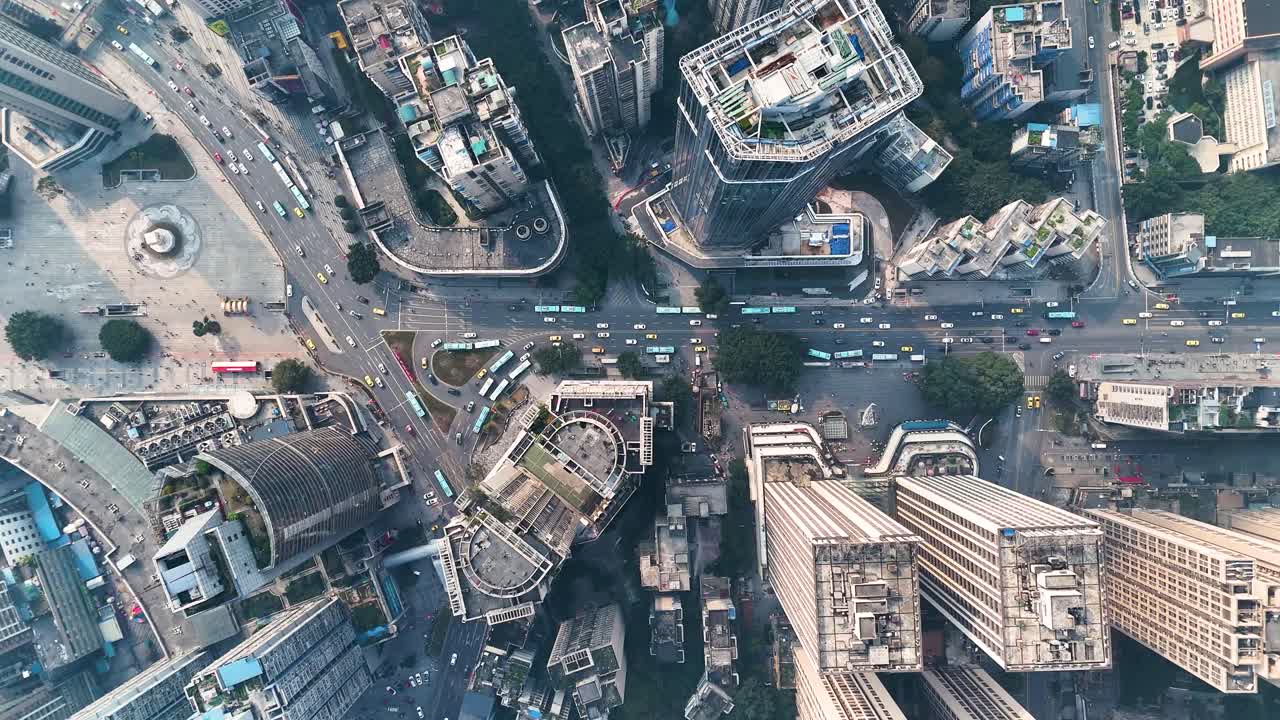 Top-Down drone view of busy traffic in Chongqing, China, with multiple roads intersecting at a central point. A snapshot of the city’s bustling urban environment and complex infrastructure.