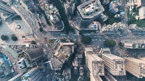 top-down drone view of busy traffic in chongqing, china, with multiple roads intersecting at a central point. a snapshot of the city’s bustling urban environment and complex infrastructure.