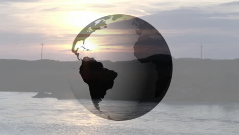 transparent globe hovering over coastal sunset scene, reflecting warm golden hues on calm water
