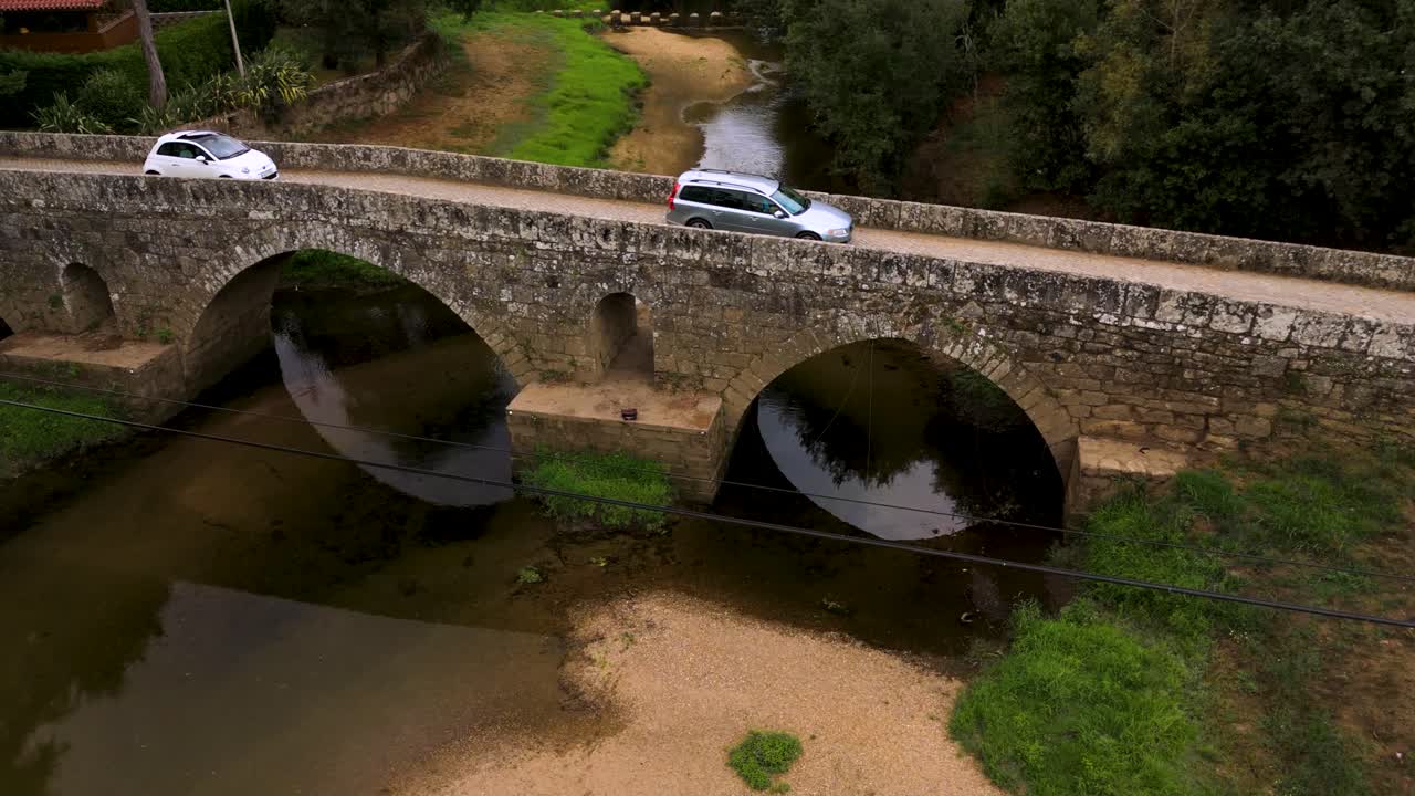 Car crossing Roman Bridge in Ponte de Lima, Portugal on a peaceful day