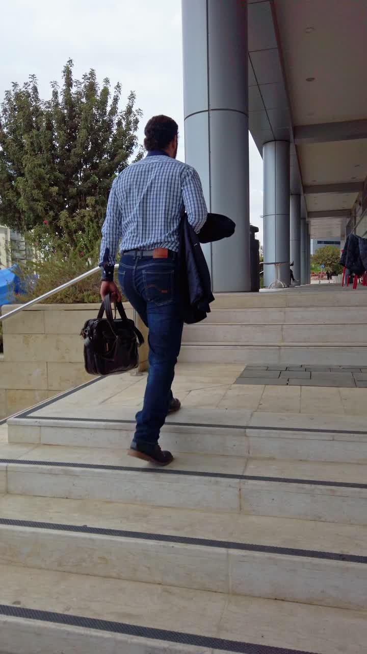 Young Businessman Arriving at Office Building