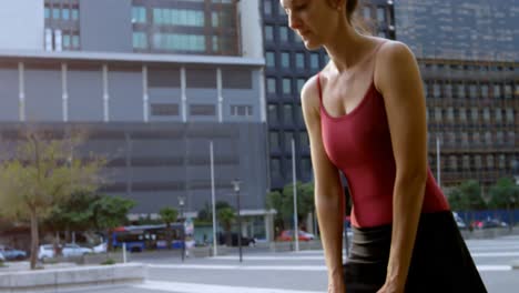 Female-ballet-dancer-performing-on-pavement-in-the-city-4k