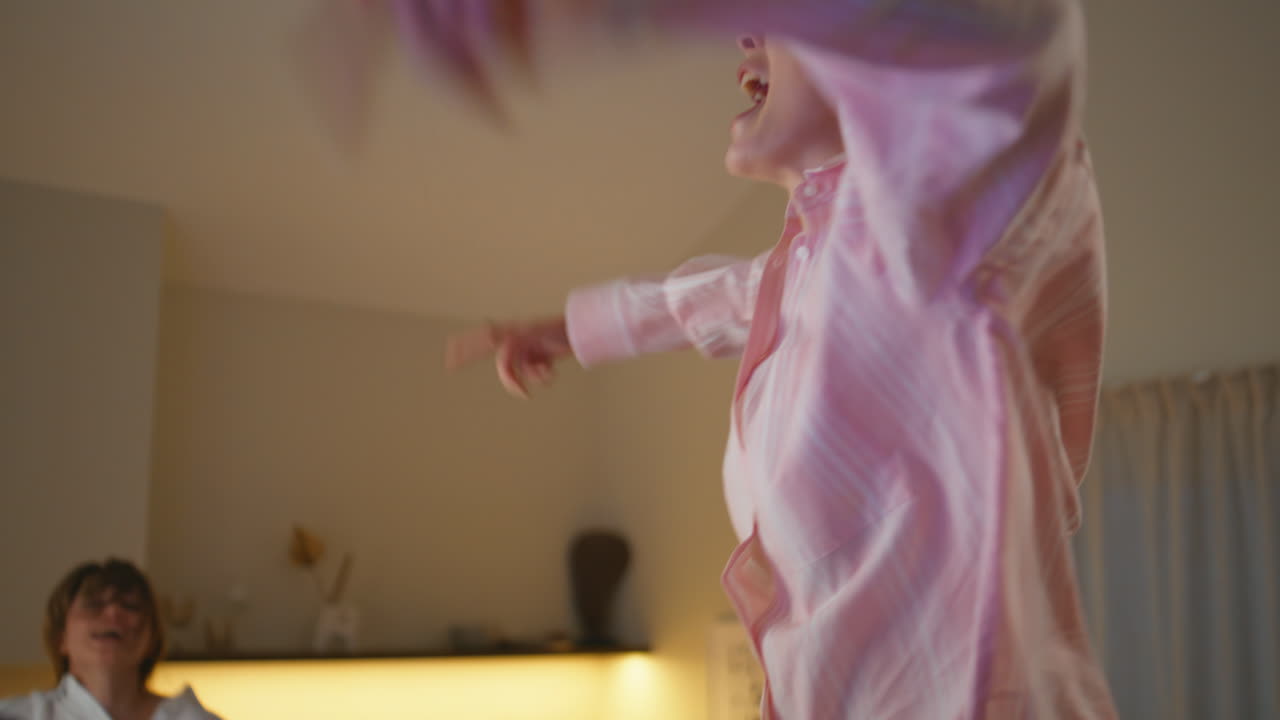 Joyful friends pajamas jumping having fun at evening bachelorette party closeup