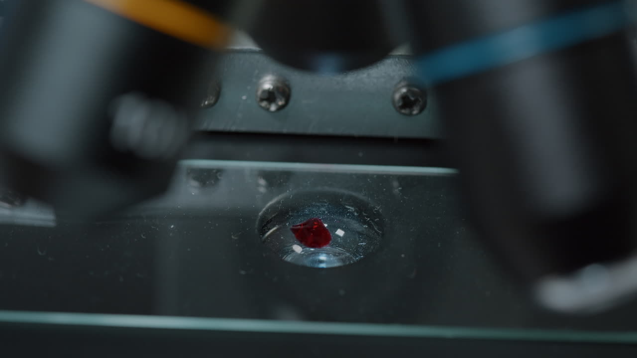 Micro pipette dropping blood sample on microscope tray