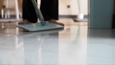 woman mopping a tile floor