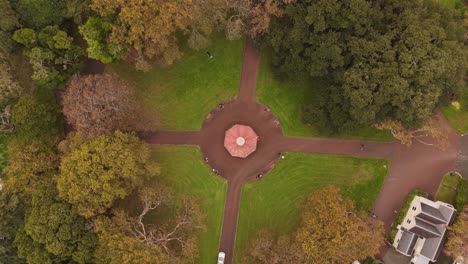 albert park, symmetrical design, fountain, people, auckland, new zealand. aerial top-down orbiting
