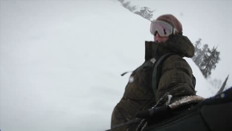 a snowboarder records himself while boarding down a slope