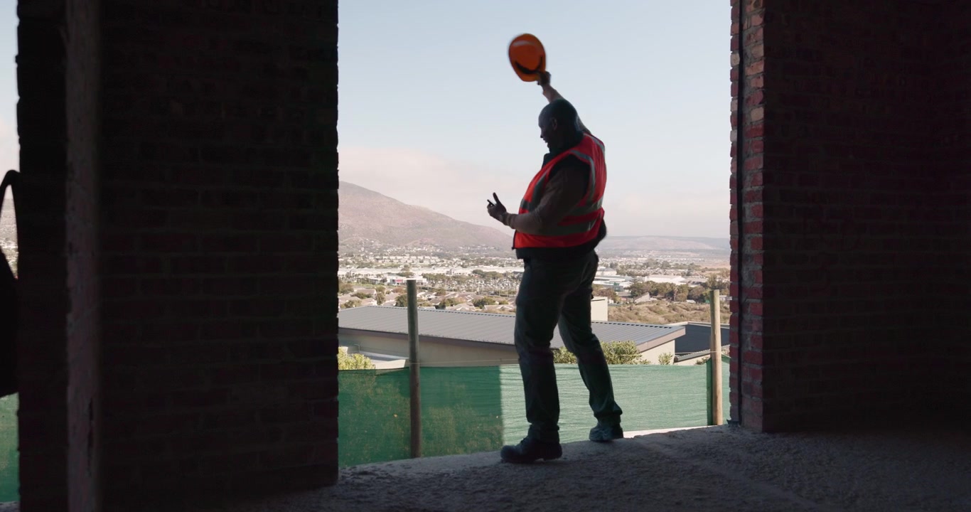 Construction Worker Dancing and Celebrating on Building Site