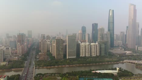 sunny evening guangzhou city downtown traffic bridge famous stadium riverside aerial panorama 4k china