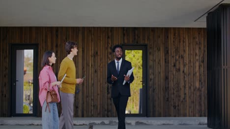 real estate agent showing property to couple