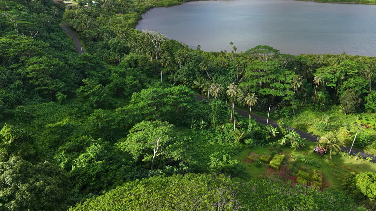 French Polynesia. Aerial View of Green Tropical Island Lush, Road and Rainforest on Volcanic Hills Above Bay