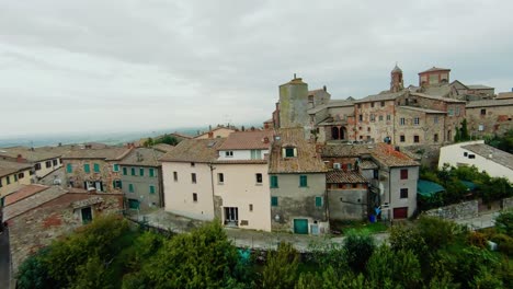 Fly-Over-Walled-Medieval-Town-Of-Lucignano,-Province-of-Arezzo,-Tuscany-Italy