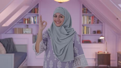 happy muslim woman showing okay sign