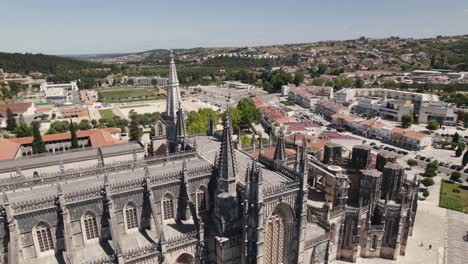 aerial backwards view of the monastery of batalha, with some details of gothic roof