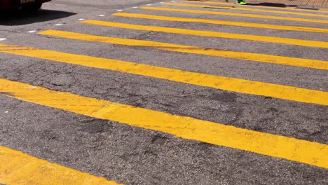 bicycle and car crossing a busy road