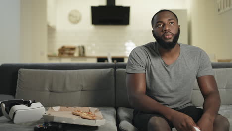 Nervous-man-changing-channels-sitting-in-kitchen