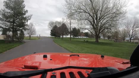 Driving-a-red-vehicle-in-the-Scooteney-State-Park-with-camp-sites-on-the-right-and-left