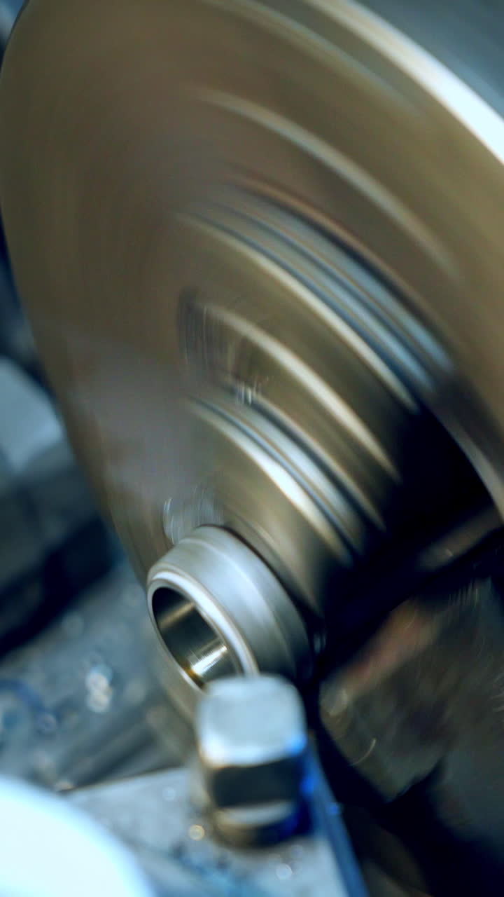 Factory of metal products. Industrial machine tool equipment, close up. Vertical video