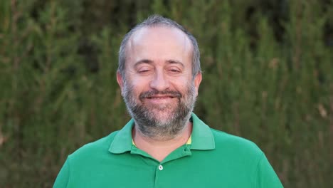portrait of a man with a beard in a green shirt
