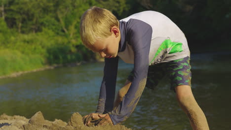 little boy playing on the lake shore - close up