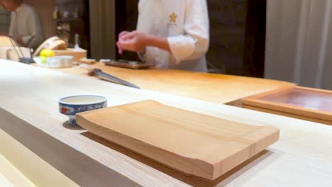 chef skillfully prepares sushi in a restaurant