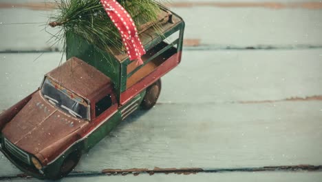 model car with christmas tree on its roof combined with falling snow