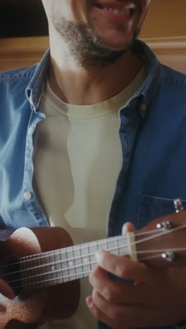 man playing ukulele in a camper van