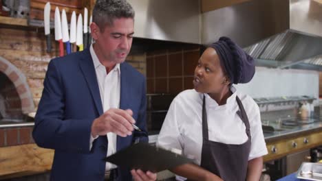 caucasian man talking to a chef