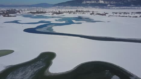 spring ice drift on the frozen winter river lake overflight - drone collection stock video