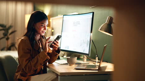 woman working at home office with computer and smartphone