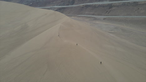 tourist hiking the dune of iquique