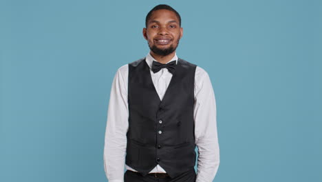 portrait of bellhop hotel employee posing with arms crossed