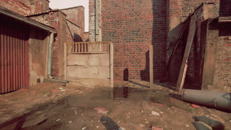 a narrow alley with a brick wall, a rusty gate, and a trash can