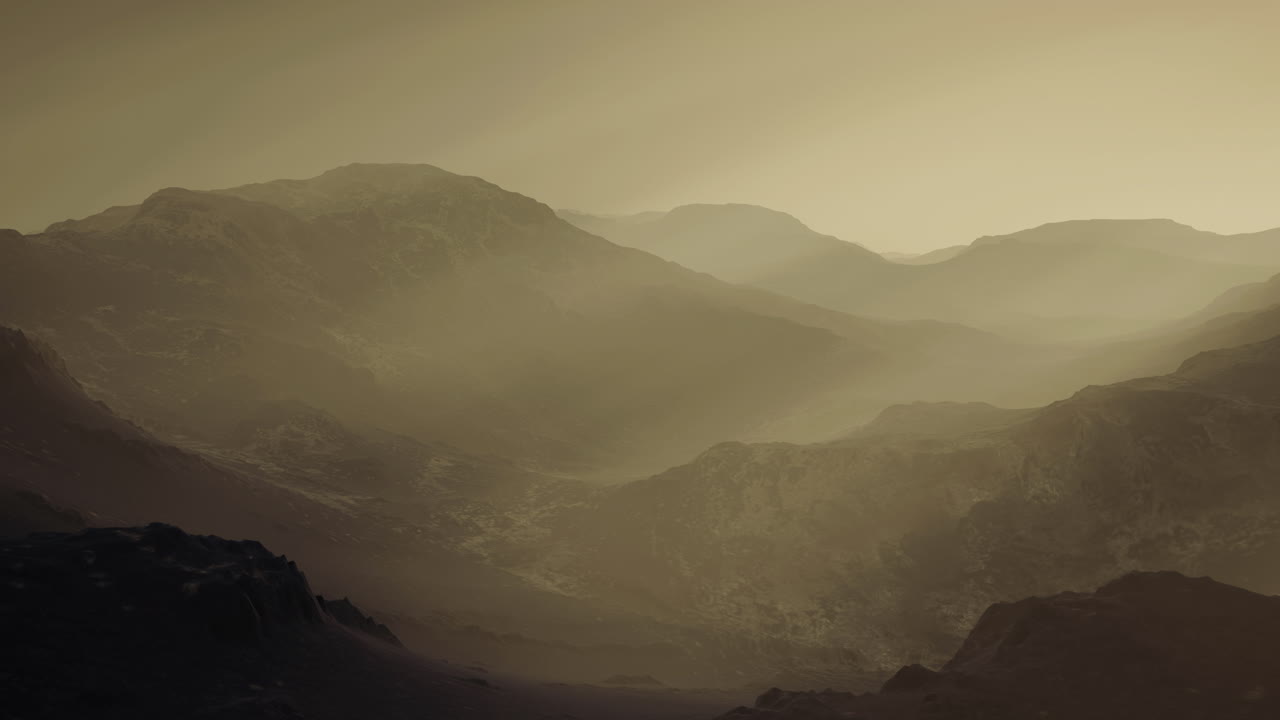 Majestic mountain landscape shrouded in mist at dawn in a quiet valley