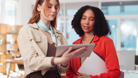 two businesswomen collaborating in modern office