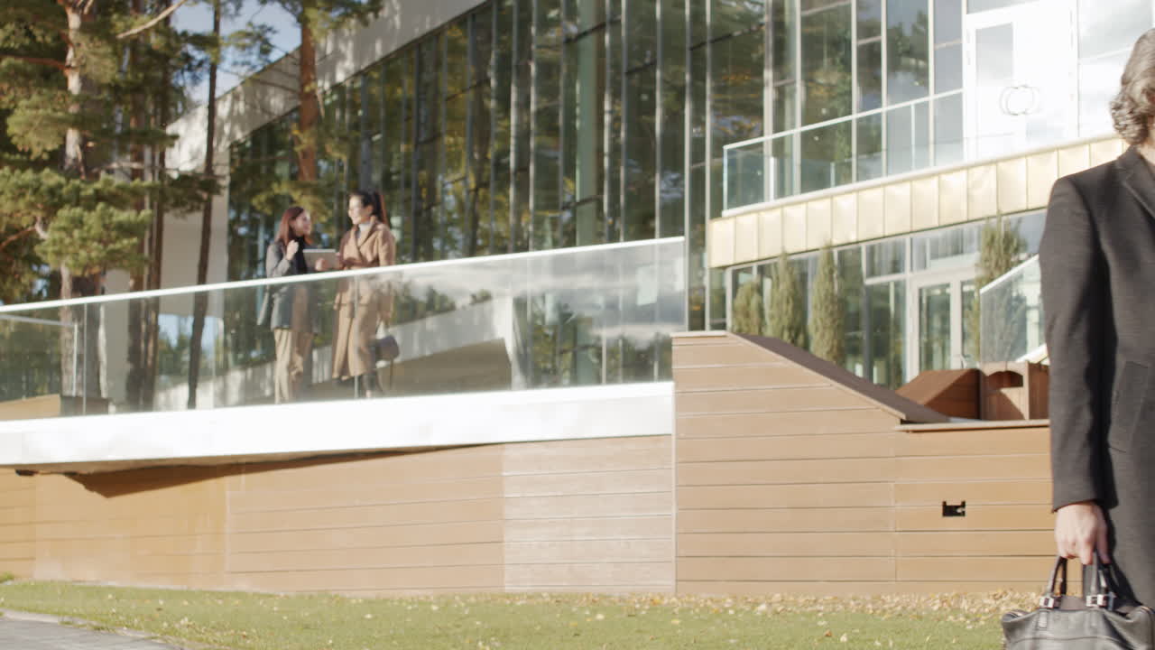 Businessman on Hoverboard Using Smartphone Outside a Modern Building