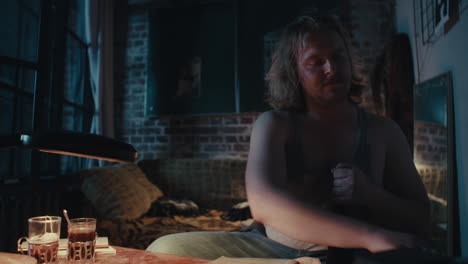 man drinking alone at night