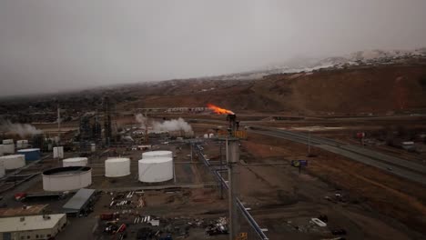 a gloomy winter day along the great salt lake reveals a fuel factory with rising platforms and miles of pipes layout like a puzzle