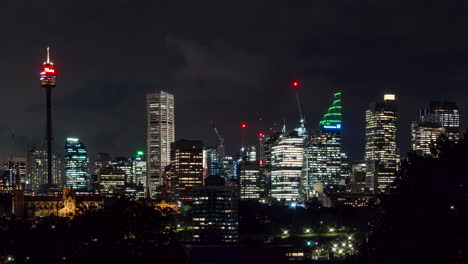 night timelapse of sydney tower, lights of downtown sydney, australia