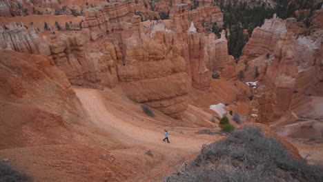 Woman-Walking-Alone-on-Hiking-Trail-in-Bryce-Canyon-National-Park,-Utah-USA,-Wide-View