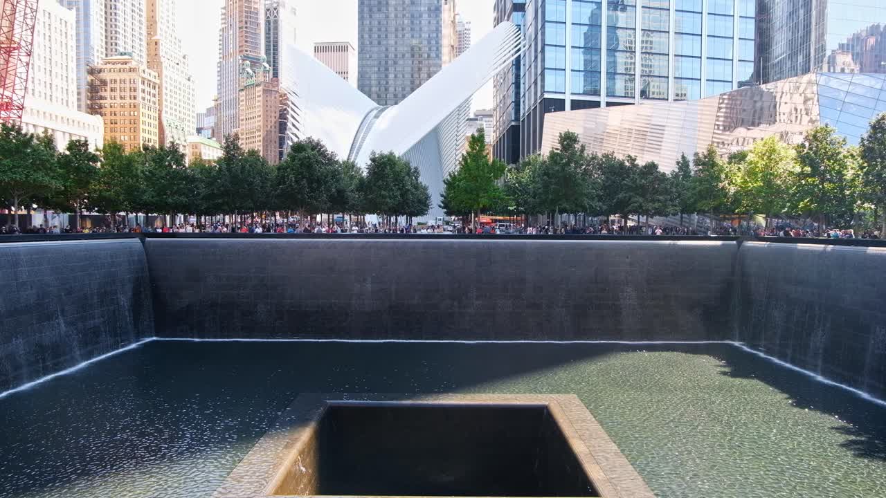 People walking near Memorial fountain in New York