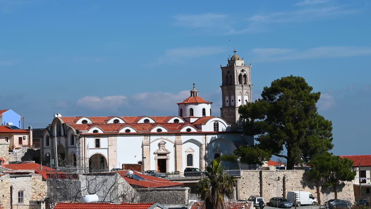 Panoramic view over Pano Lefkara, Larnaca District, Cyprus, featuring stone houses with terracotta roofs and the Church of the Holy Cross bell tower rising above the village
