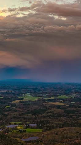 dark storm clouds roll over a rural landscape in a vertical time lapse shot