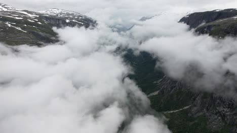 clouds covering the valley simadal in norway and the mountains drone shot