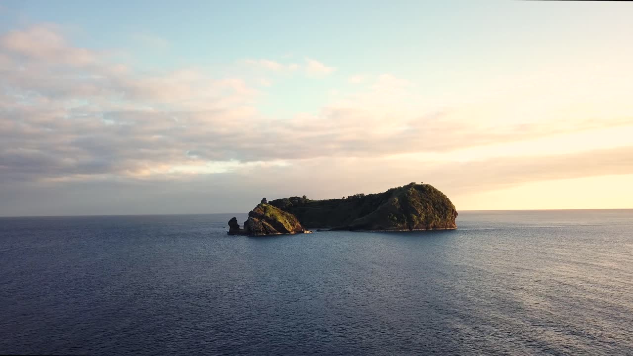 Panoramic aerial drone footage of Vila Franca do Campo island at sunset located in Azores.