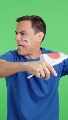 man cheering for japan, angry with the decision of referee