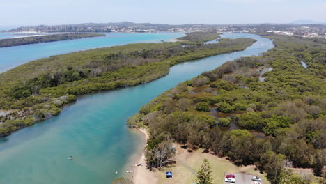 Descending-over-the-Pelican-island-and-Hastings-River-at-the-Woregore-Nature-Reserve-Australia,-Aerial-View